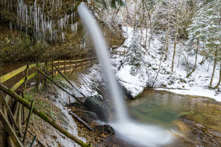 The beautifully icy Scheidegger waterfalls with a hike in the areaの写真素材