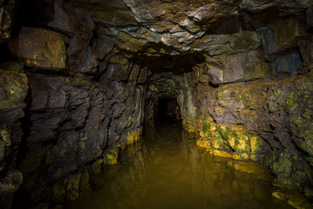 An old abandoned mining facility an ore mine tunnel system undergroundの写真素材