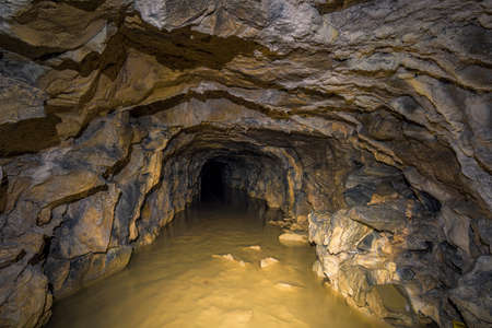 An old abandoned mining facility an ore mine tunnel system undergroundの写真素材
