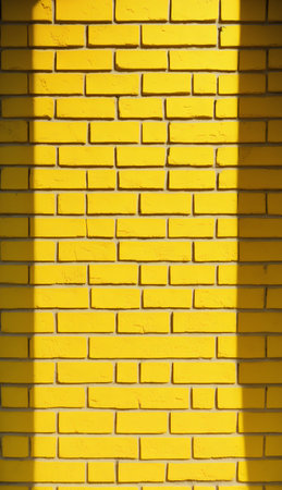 Yellow brick wall with sunlight. Abstract background and texture for design.