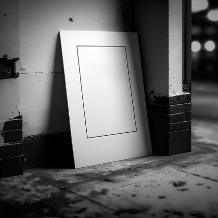 Blank photo frame on wall in old building. Black and white.の素材