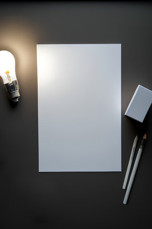 Design concept - top view of creative mockup of business card, lamp, pencil and eraser on black background for mockupの素材