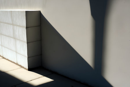shadow of the sun on the wall of a building with white wallsの素材