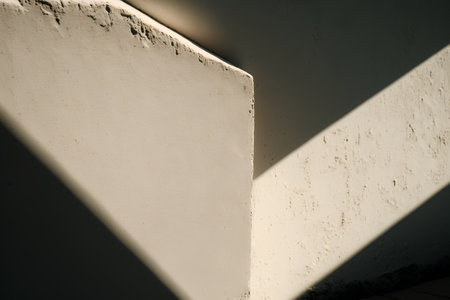 White concrete stairs with shadow from the sun on the wall. Abstract background.の素材