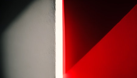 Red and white wall with light from the window. Abstract background.の素材