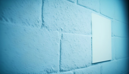 Blank white sign on blue brick wall background with copy space.の素材
