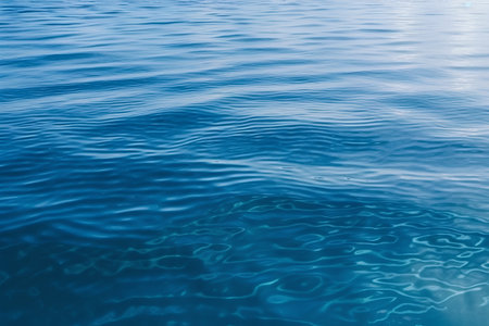 Blue water surface with ripples in the sea, close-upの素材