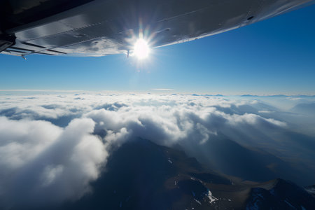Aerial view of clouds and blue sky from a plane window.の素材