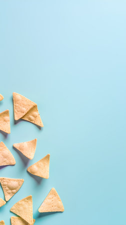 Mexican nachos on blue background. Top view, copy spaceの素材