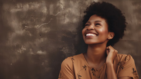 Portrait of a young african american woman smiling with closed eyesの素材