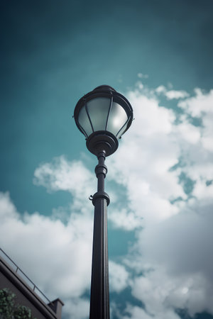 Lamp post on blue sky background, retro style toned pictureの素材