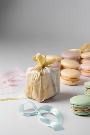 Gift box and macaroons on white background, selective focusの素材