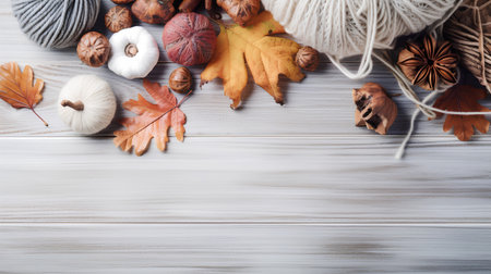 Autumn composition with dried leaves, nuts and yarn on wooden backgroundの素材