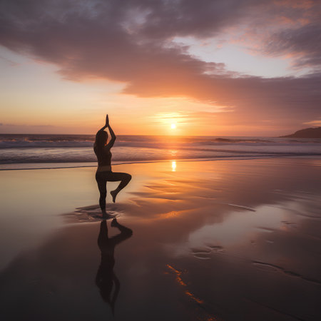 Silhouette of woman practicing yoga on the beach at sunset.の素材
