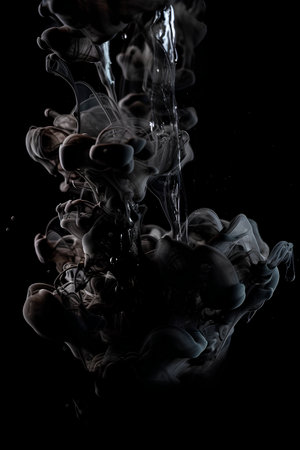 Splash of ink in water on a black background. Abstraction.の素材