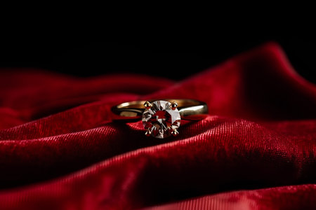 wedding rings on red satin background with shallow depth of fieldの素材