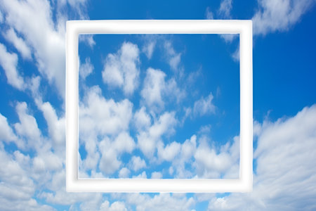 White frame on blue sky background with white clouds. Place for your textの素材