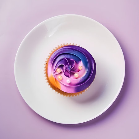 Colorful cupcake on white plate on purple background. Top viewの素材