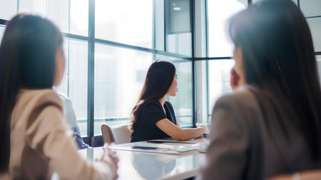 Group of business people discussing the charts and graphs showing the results of their successful teamworkの素材