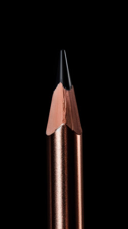 close up of a brown lipstick on a black background with copy spaceの素材