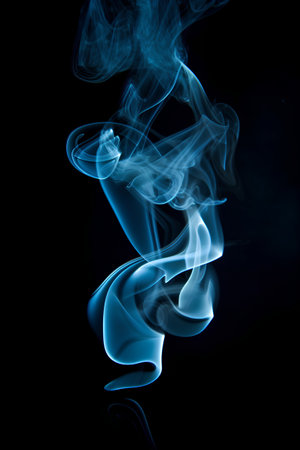 Blue smoke on black background. Abstract color background. Close up.の素材