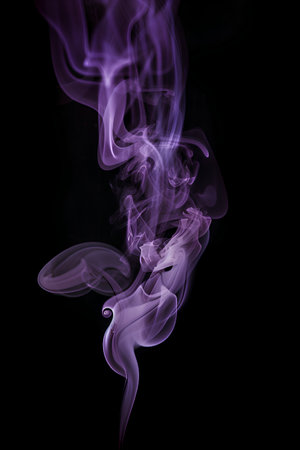 Purple smoke isolated on black background. Abstract background for design.の素材
