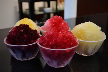 Frozen fruit ice cream in plastic cups on the table. Selective focus.の素材