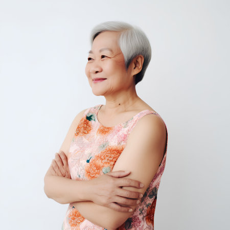 Portrait of asian senior woman with grey hair on white backgroundの素材