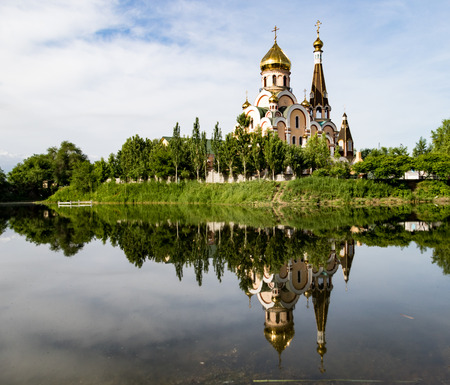 Christian church near Almaty, Kazakhstan reflected in lakeの写真素材