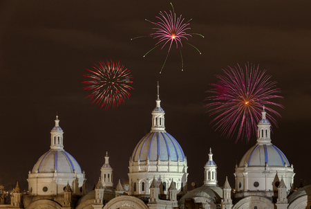Fireworks over the domes of the New Cathedral in Cuenca, Ecuador. These are the famous view that are usually found on all travel brochures for the city.の写真素材