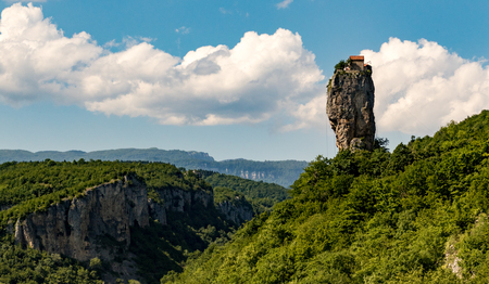 Katskhi Pillar is a single 120 foot tall towering pillar of rock with a small cell for a single monk at the topの写真素材