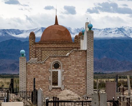 Islamic Mausoleum with snow capped mountains in backgroundのeditorial素材