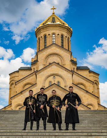 Tbilisi, Georgia - June 8, 2017: Groomsmen pose in front of the  Metekhi Georgian Orthodox churchのeditorial素材