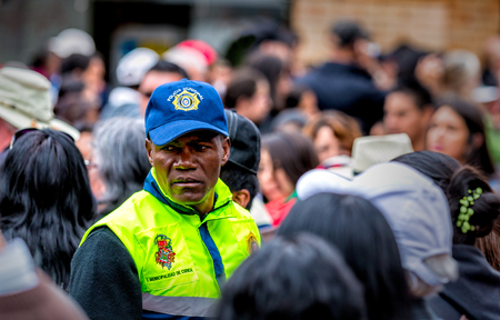 Cuenca, Ecuador - Dec 24, 2014: A security officer scans the crowd at a festival
