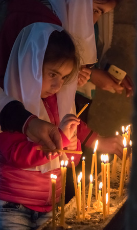 Dilijan, Armenia - June 18, 2017: Family lights candles in Hahbat Armenian Orthodox churchのeditorial素材