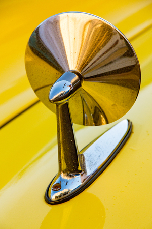 Havana, Cuba, Nov 21, 2017 - Front side mirror on 1950's Classic American yellow carのeditorial素材