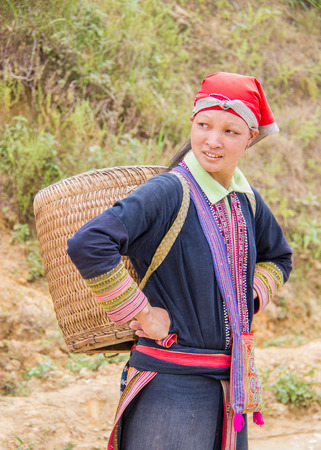 North Vietnam - Oct 21, 2011: woman carries empty basket on her backのeditorial素材