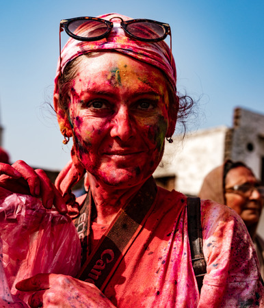 Barsana, India, Holi Festival, Feb 24, 2018 - Woman smiles while covered in paint during Holi Festival in Indiaのeditorial素材