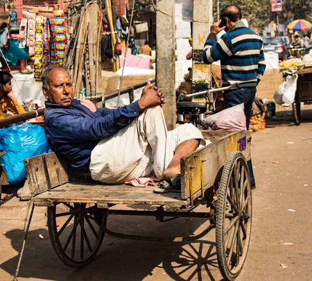 new Delhi, India, Feb 19, 2018 - Man rests in his cart in the middle of the dayのeditorial素材