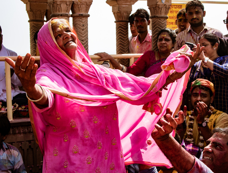 Barsana, India, Holi Festival, Feb 23, 2018 - Old woman with only one tooth dances at Indian Holi...
