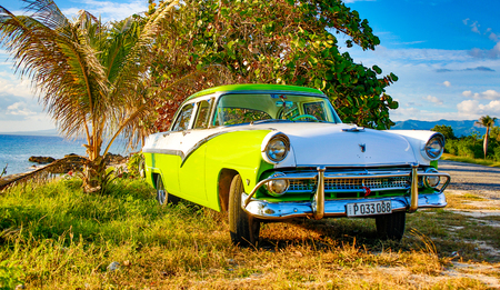 Trinidad, Cuba, Nov 28, 2017 - Green and white 1950's Class America  Ford Fairlane parked on beachのeditorial素材