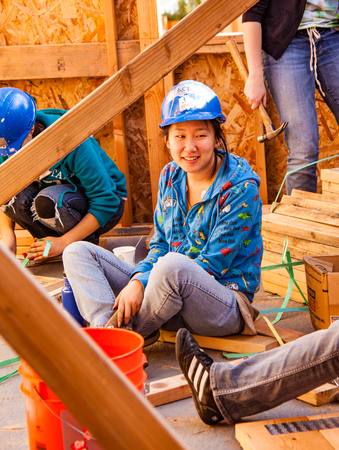 Oakland, California, USA - Jan 22, 2011: Woman talks while working for Habitat For Humanity. El Rinconのeditorial素材