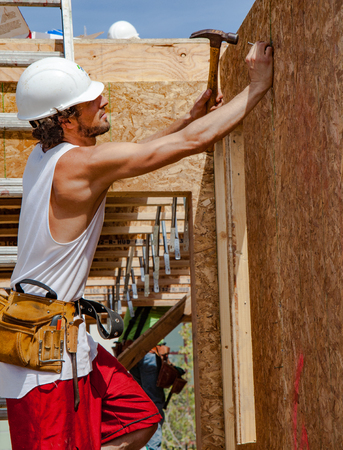 Oakland, California, USA - Apr 16, 2011: Man builds wall for home for Habitat For Humanity, Kinsell Commonsのeditorial素材