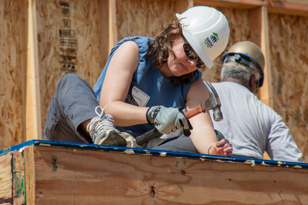 Carpenter works on building roof of new home for Habitat For Humanity charity on Jan 11, 2011のeditorial素材