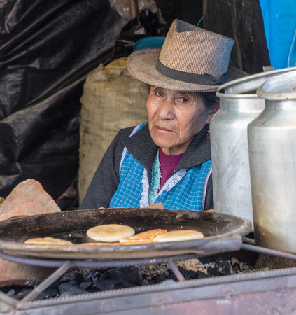San Bartolome, Ecuador Aug 24, 2017 - Vendor looks out from her stand selling pancakesのeditorial素材