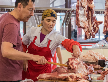 Bishkek, Kyrgyzstan - May 27, 2017: Vendor sells meat at a local market