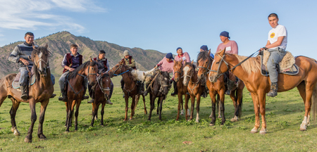 Issyk Kul, Kyrgyzstan - May 29, 2017: Horsemen play a game with a headless goatのeditorial素材