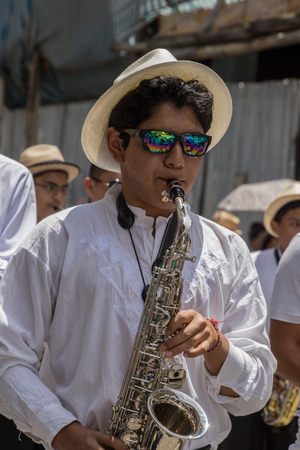 Cuenca, Ecuador - Nov 2, 2016: Boy plays saxophone in marching bandのeditorial素材