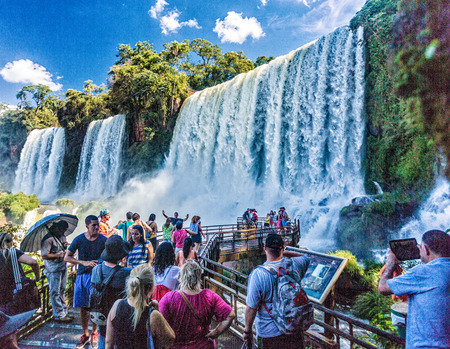 Iguazu Falls, Argentina - Apr 1, 2015: This is one of the falls in Iguazu Falls that you can approach and feel the raw power of all that power.  Tourists come with their cameras to get a photo up close and personalのeditorial素材