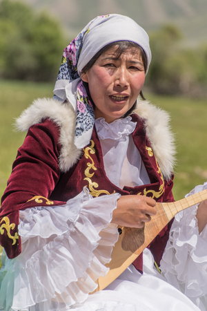 Almaty, Kazakhstan - June 3, 2017: Woman plays traditional string instrumentのeditorial素材